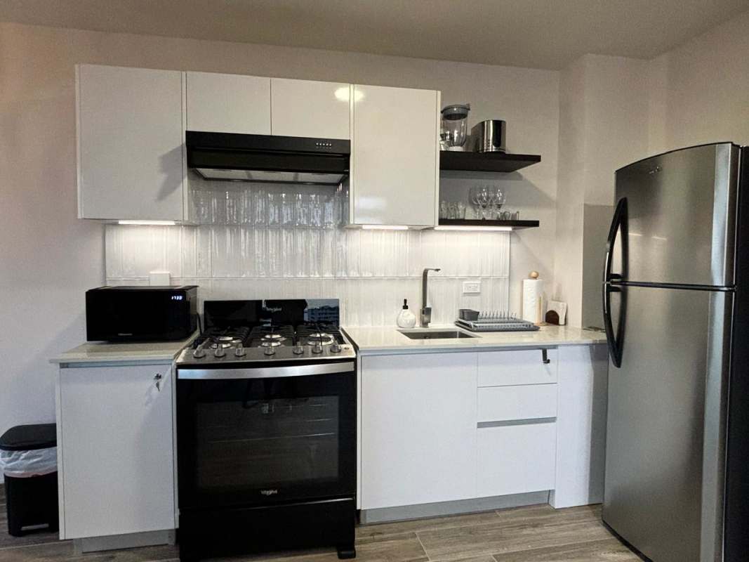 Modern kitchen with stainless steel appliances, white cabinets, tile backsplash in PH Casco View Casco Viejo