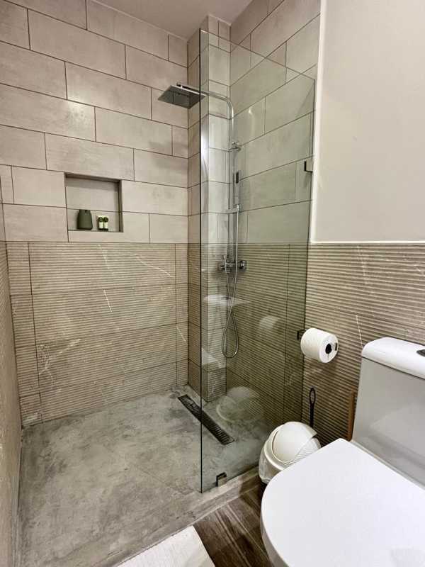 Modern bathroom with glass walk-in shower and beige tiles in PH Casco View Casco Viejo Panama City