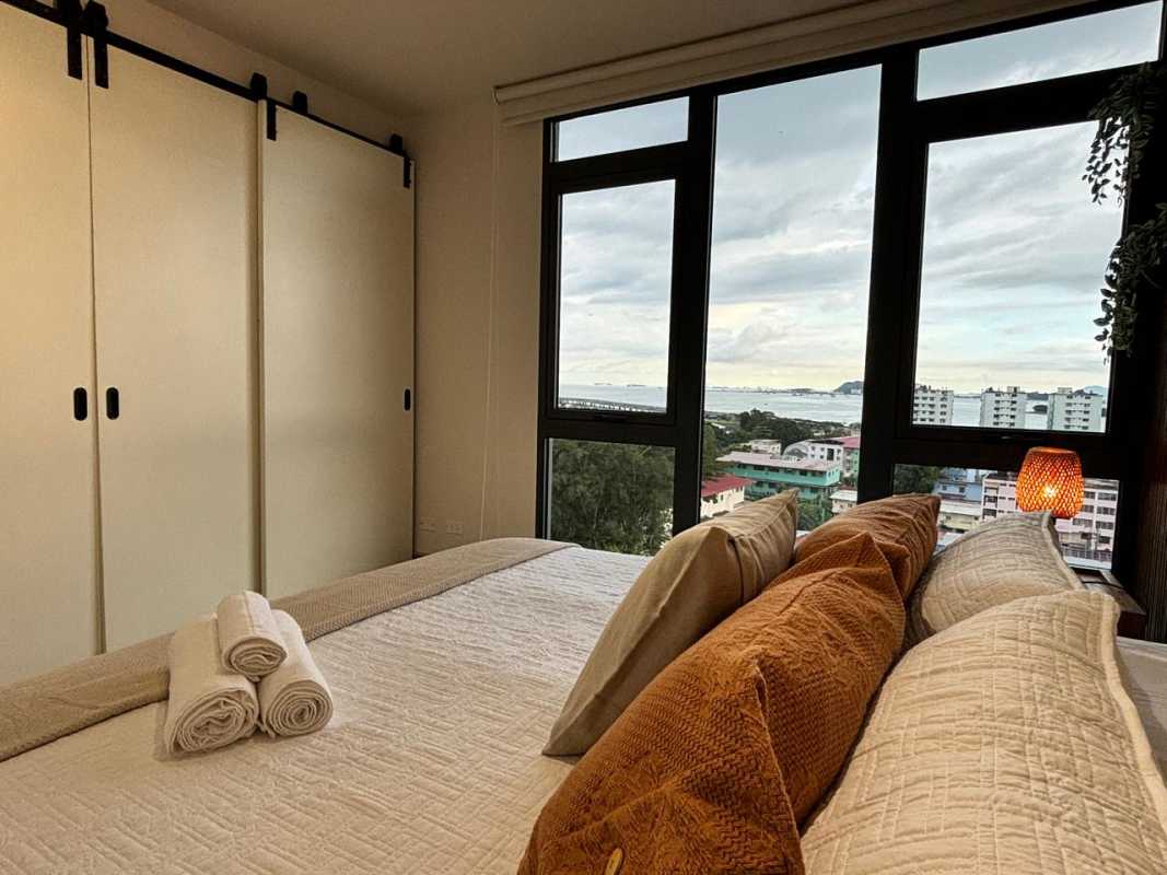 Bedroom with floor-to-ceiling windows ocean and skyline views PH Casco View Casco Viejo Panama