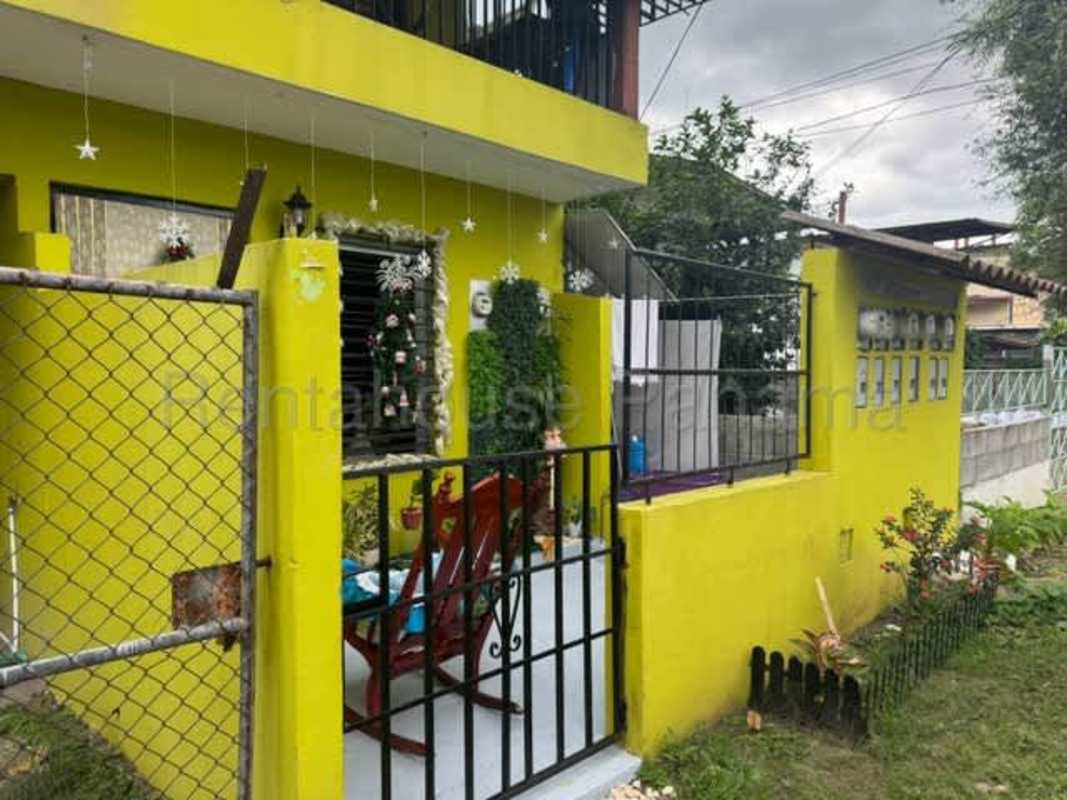 Urban street with houses, cars, and power lines Rio Abajo area Panama City