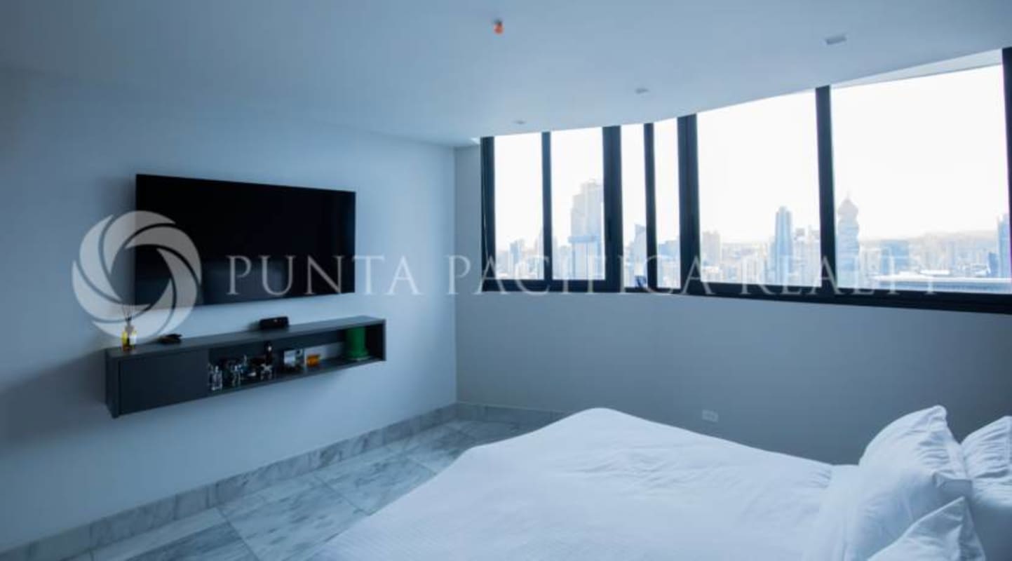 Master bedroom with floor-to-ceiling windows city view marble floors at PH Ocean Front penthouse Panama