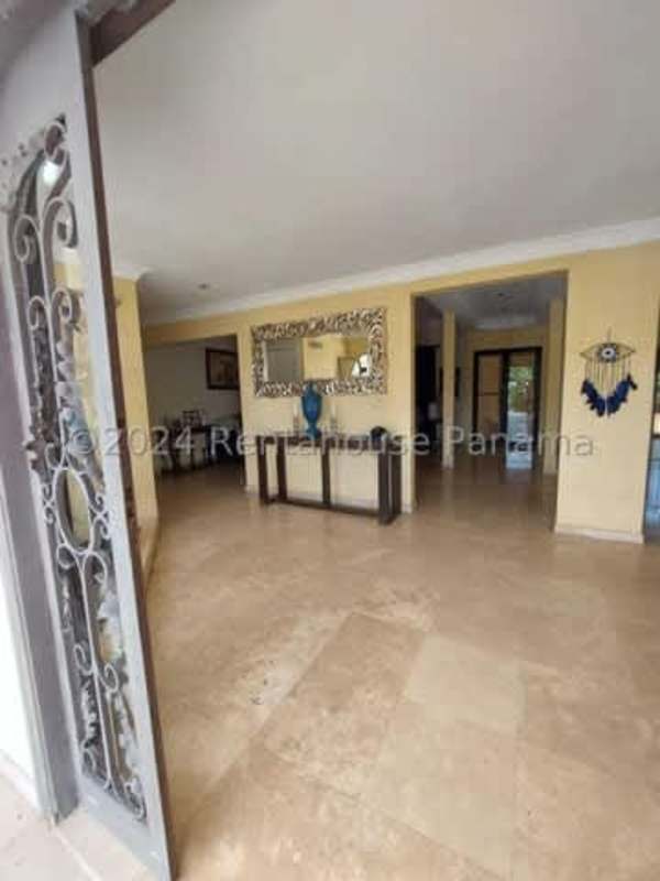 Living room with open layout, columns, large windows and tile floors Las Cumbres residential Panama