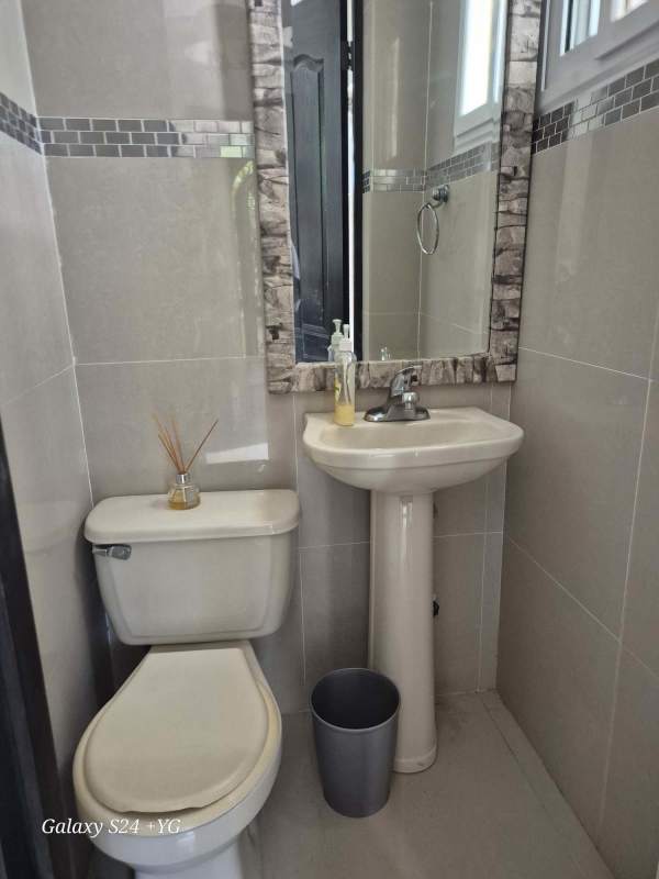 Contemporary kitchen with granite counters, blue cabinetry, stainless appliances in house for rent Condado del Rey Panama