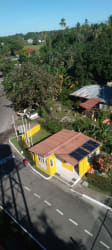Flower lined pathway surrounded by tropical plants and trees in Los Lirios San Carlos