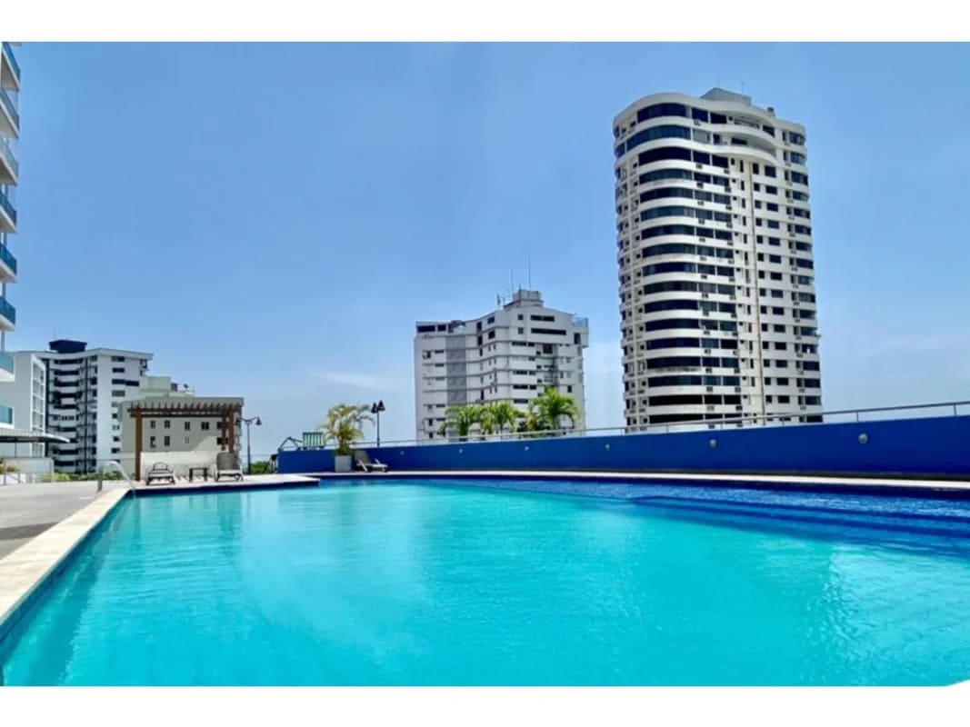 Spacious outdoor swimming pool, sun deck and high-rise background at PH Cabomarzo Panama City