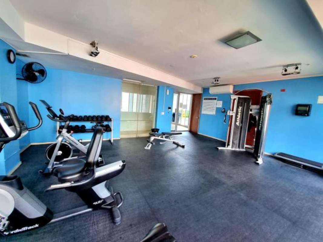 Modern children's playground with city and ocean backdrop on rooftop of PH Cabomarzo Panama City