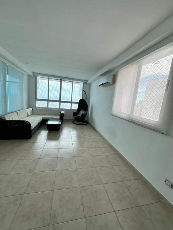 Spacious bright living room with large glass windows and city views in PH Cabomarzo Panama