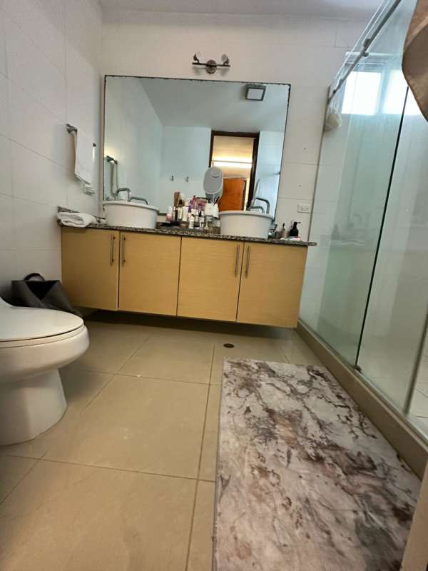 Modern glass balcony with outdoor furniture and ocean skyline view in PH Cabomarzo Panama City