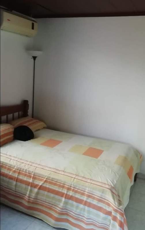 Simple suburban backyard with patio, lawn, dog house, grill setup in Praderas de San Antonio Panama