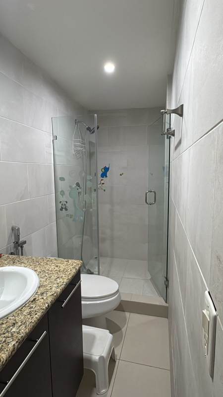 Children's bedroom with pink accents, study desk and decorative art wall in Los Guayacanes house