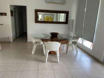 Mediterranean white apartment building with balconies tropical landscaping at Bijao Resort Panama