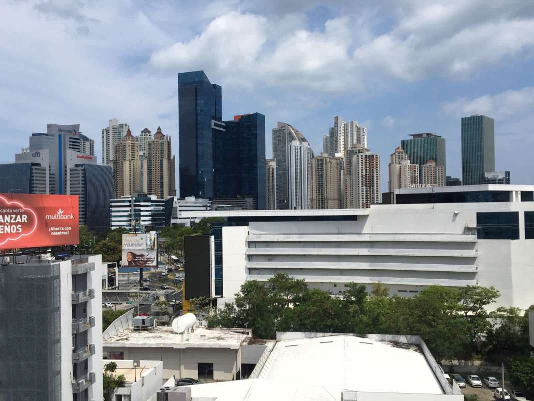 Dining room area with six chairs, striped upholstery and pendant lamp at PH Don Camilo Panama City