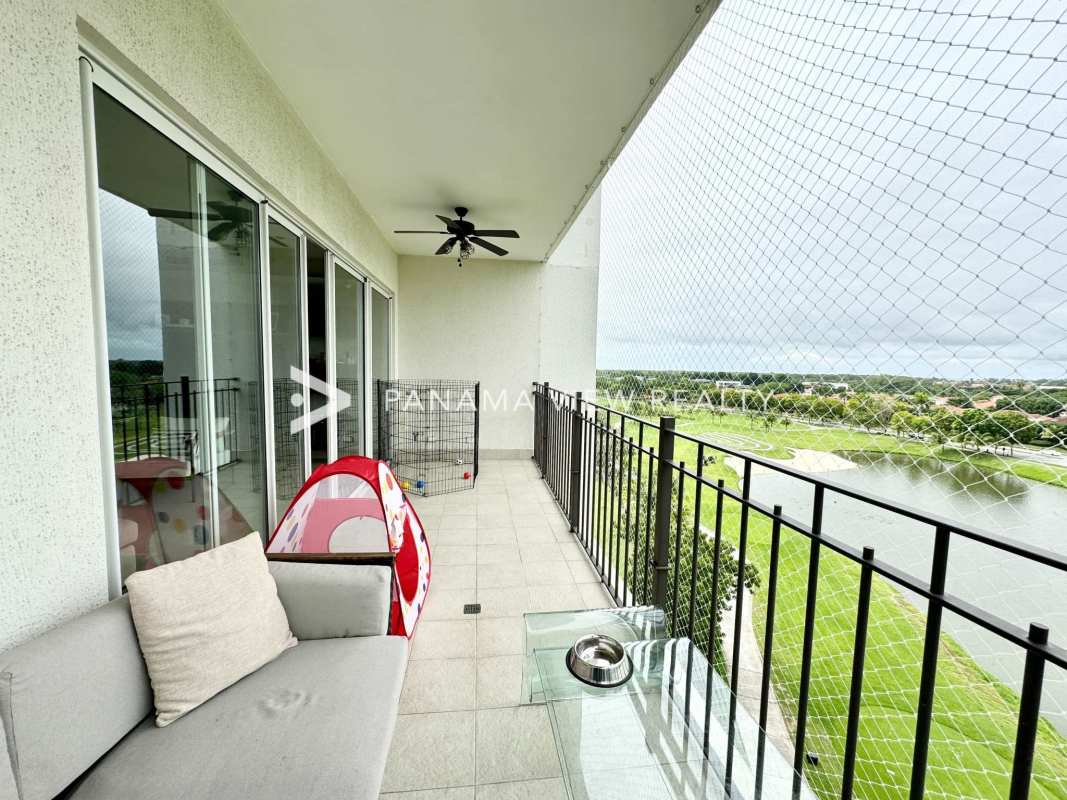 Modern kitchen with island peninsula adjacent dining area in luxury condo The Reserve Santa María Panama City
