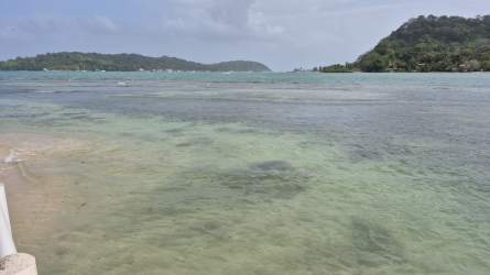 Caribbean-style two-level beach house blue and white facade with balconies Isla Grande Panama