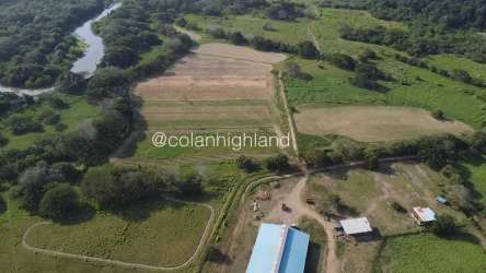 Aerial overview of fertile farmland near river in La Villa de Los Santos ranch Panama
