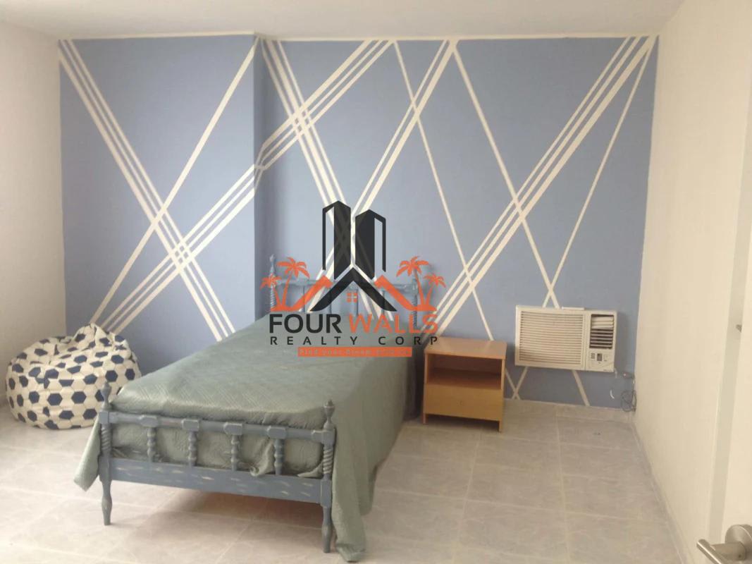 Bedroom with large windows showing sea views in PH Rocomar Panama City