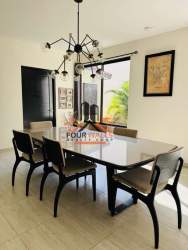 Bright dining area with glass table, six chairs, contemporary lighting Howard Capira Panama