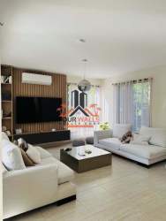 Contemporary entrance with black front door, chandelier, wood slat feature Howard Capira Panama