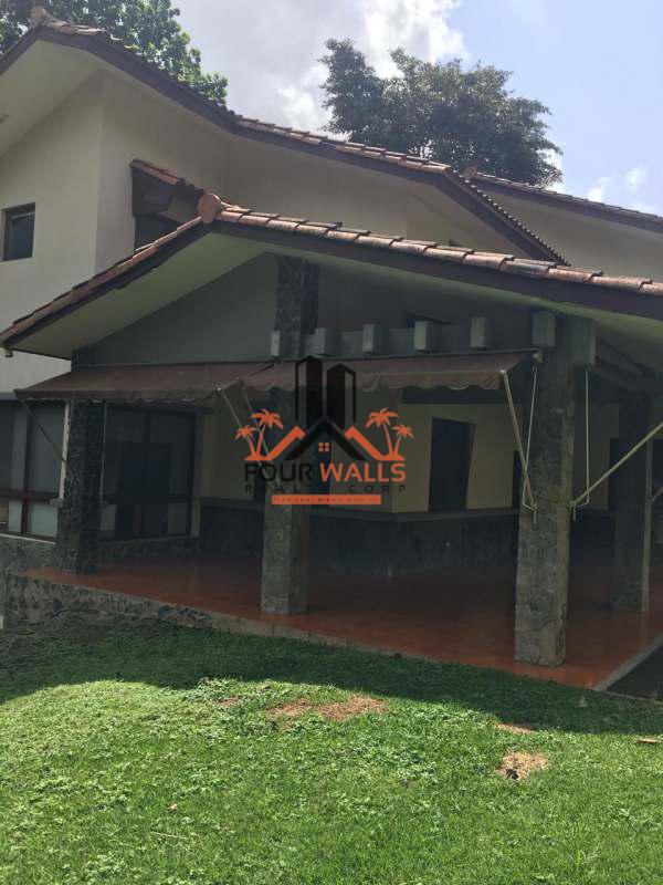 Rustic Mediterranean patio with stone columns tiled roof and garden PH Camino de Cruces Panama