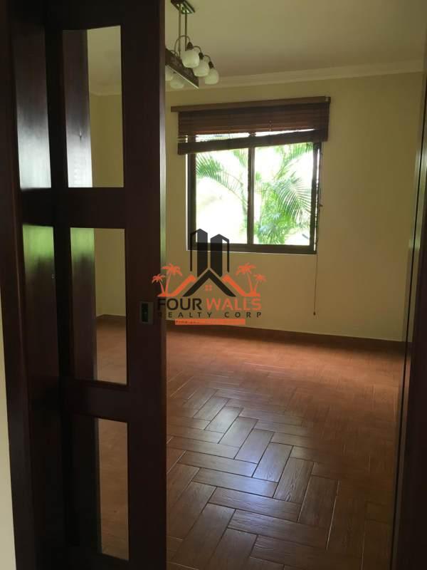 Spacious empty bedroom with wood style tile floor large window in PH Camino de Cruces Clayton Panama