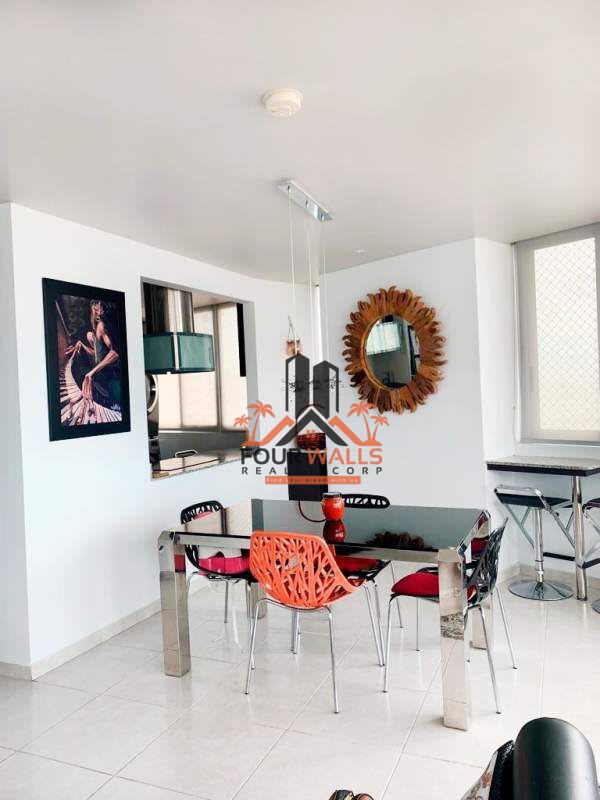 Modern dining space near large window with city and ocean view PH Bay View Avenida Balboa Panama