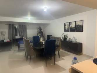 Dining area with round table, upholstered chairs, art decor Las Villas de Arraiján Panama