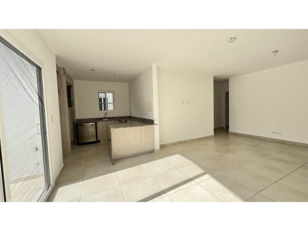 Bright open-concept living dining area with tile floors and patio access in Costa Sur Panama