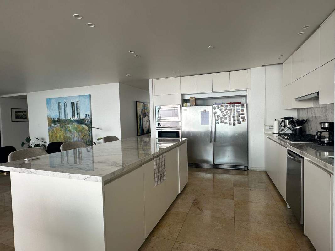 Modern hallway with marble flooring, console table and contemporary artwork inside PH Venetian Tower Coco del Mar Panama