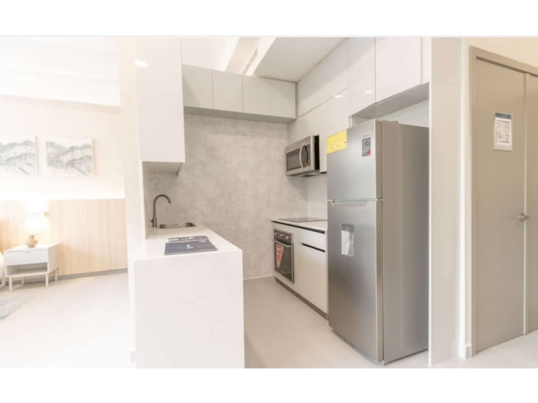 Modern minimalist kitchen and open dining area with appliances in Seaside House avenida Balboa