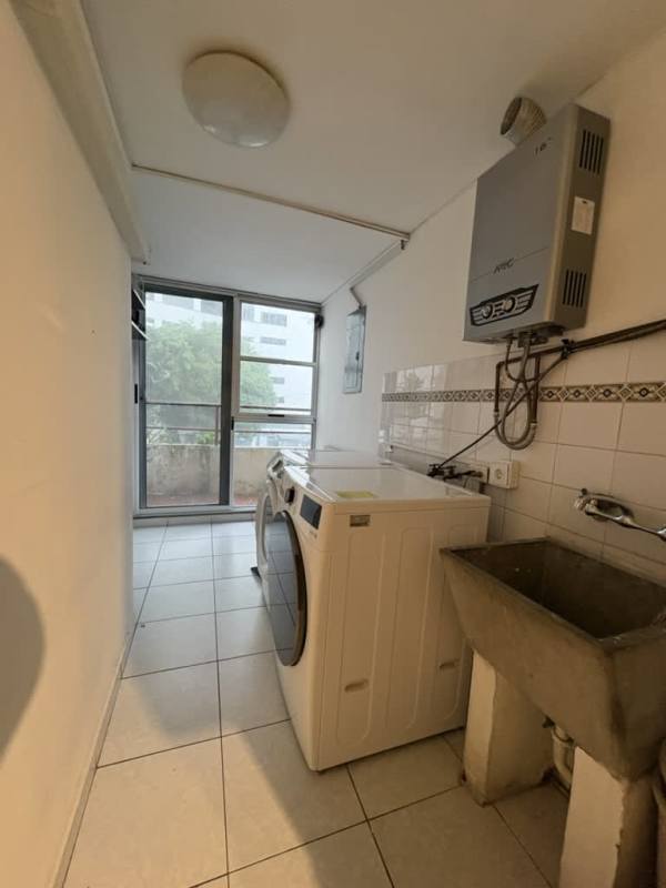 Laundry room with washing machine hookup, tankless heater, and concrete sink in PH San Francisco Panama