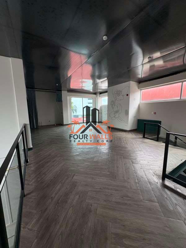 Large modern open floor plan interior with glass railings wood tile floor Punta Pacífica Panama