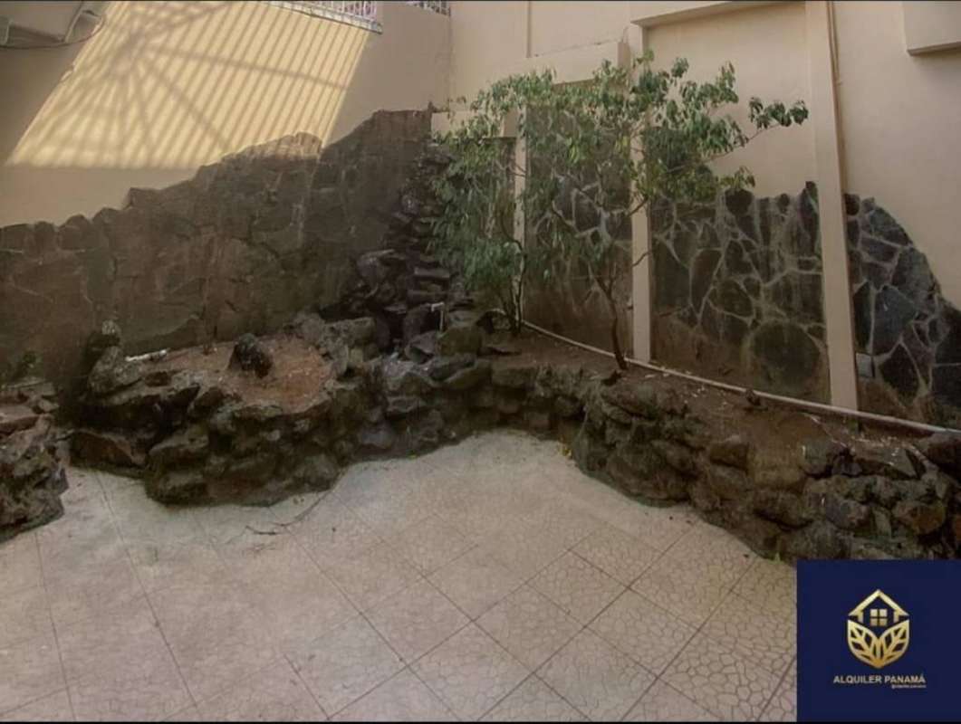 Enclosed garden patio with stone retaining wall and water feature in house for rent El Dorado Panama