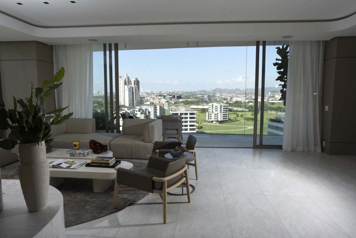 Spacious luxury apartment living room featuring floor-to-ceiling windows with golf and ocean vistas in Santa Maria Panama
