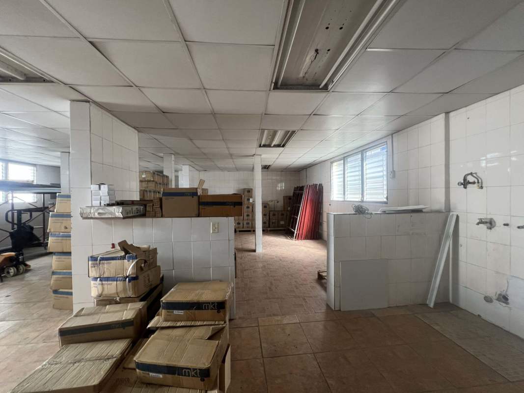 Bright empty office room with large windows and tiled floors at Commercial Building Betania