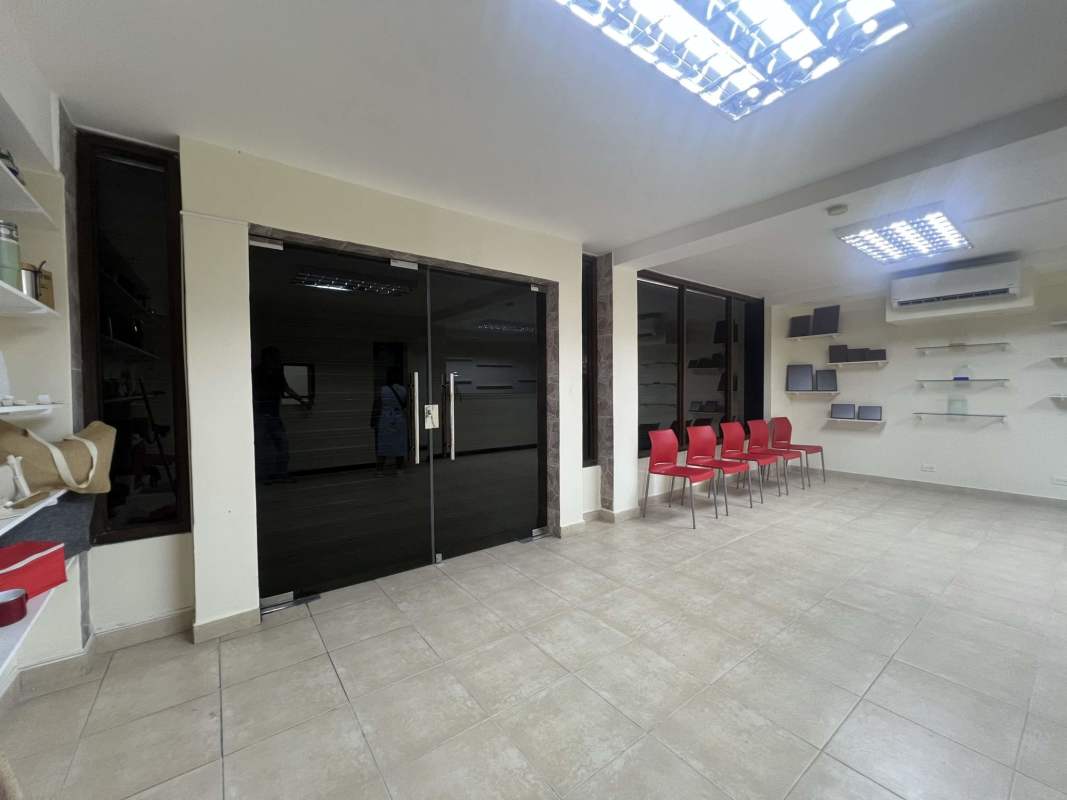 Three-story commercial building facade with large windows and parking on Avenida La Paz Betania Panama