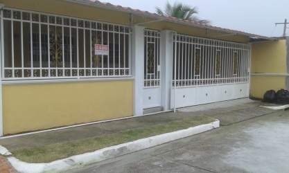 Yellow facade single-story house with metal gate driveway Brisas de Arraiján Panama