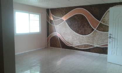 Spacious living room with accent wall design and tiled floor rental house Panama
