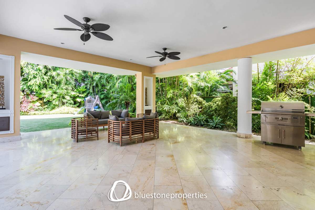 Spacious outdoor covered patio with ceiling fans and barbecue grill in luxury home Panama