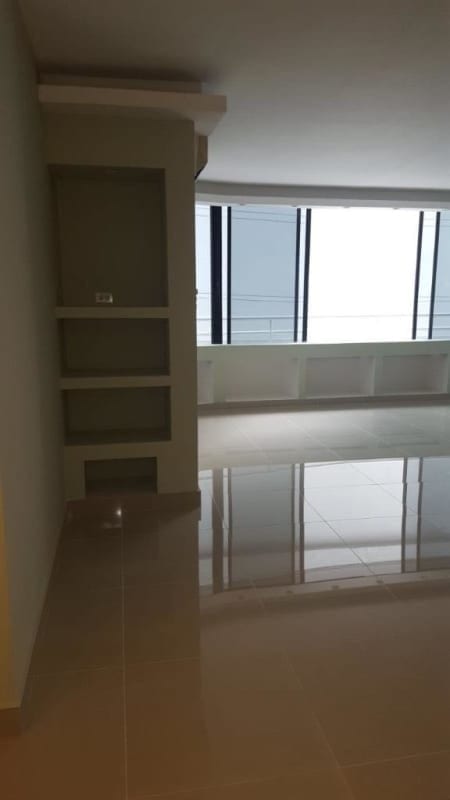 Bathroom featuring marble counter, dark vanity, and tiled walls in PH Royal Park Obarrio Panama City