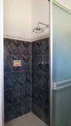 Bedroom with two beds, wooden blinds and AC at Coronado rental home