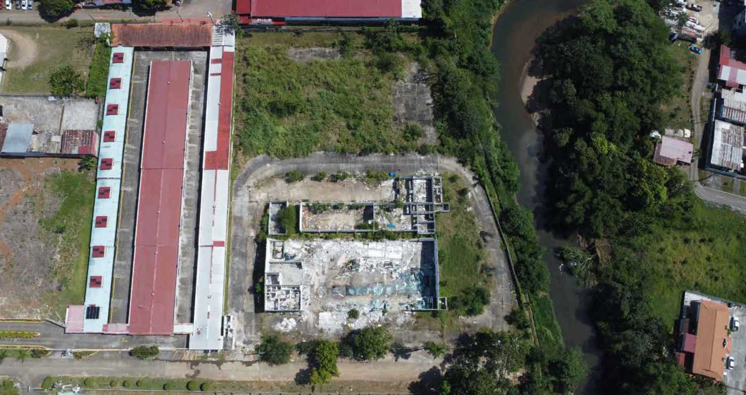 Aerial overview of industrial properties and river near Vía Tocumen land Panama City