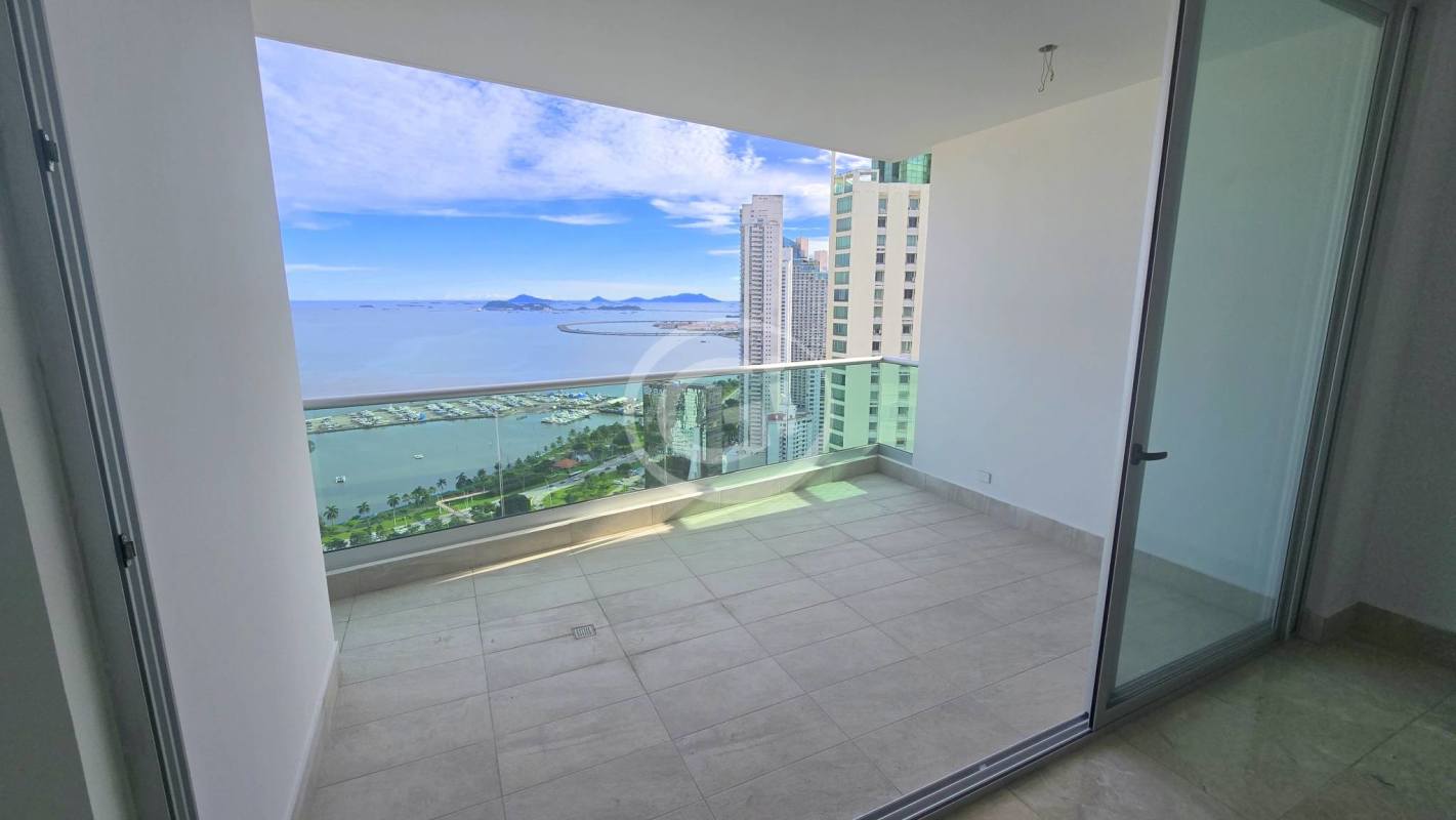 Panoramic balcony with glass railings offering ocean and skyline views at Costanera Tower South Panama