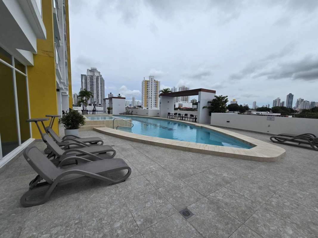 Rooftop children's play area with playset and skyline view at PH Metropolitan Park