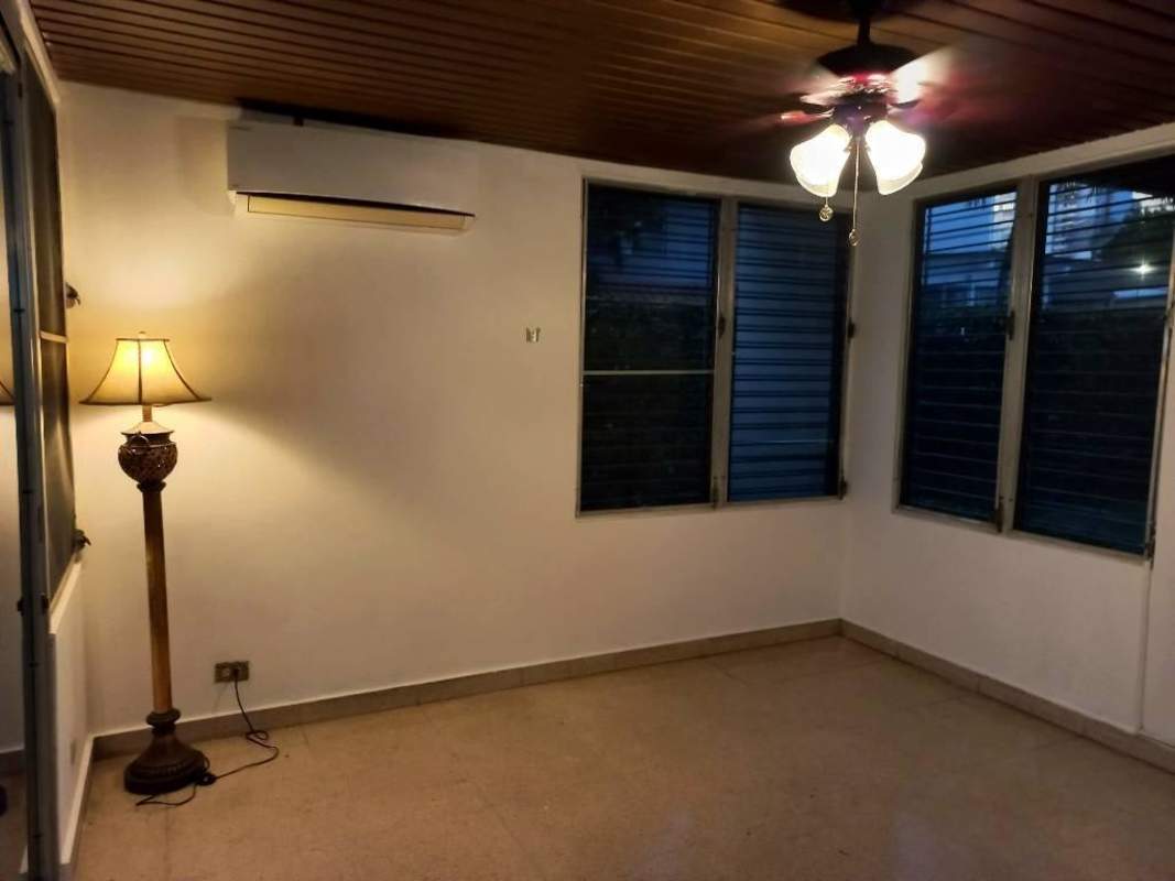Kitchen with wood ceiling, black cabinets, large window Villa Lilla Altos de Golf Panama