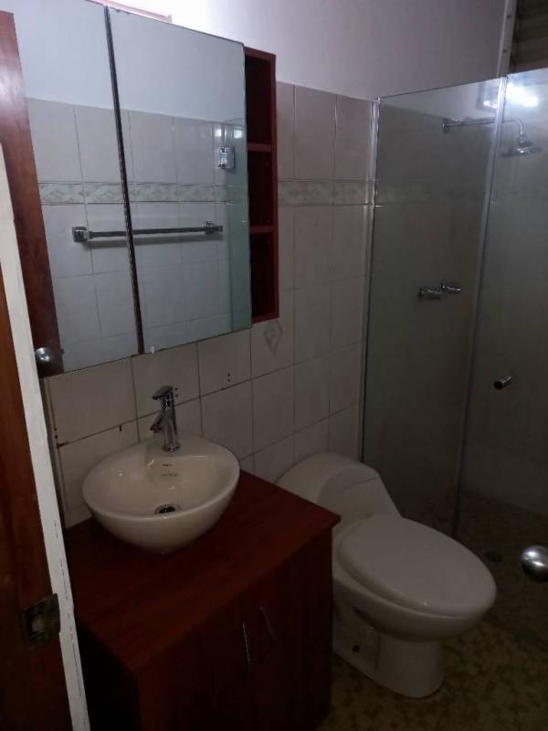 Bathroom with vessel sink, glass shower, wood vanity in Villa Lilla Altos de Golf Panama