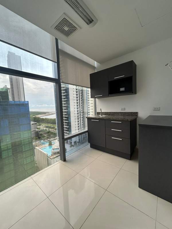 Kitchenette with modern cabinetry and city view in premium office Costa del Este Panama