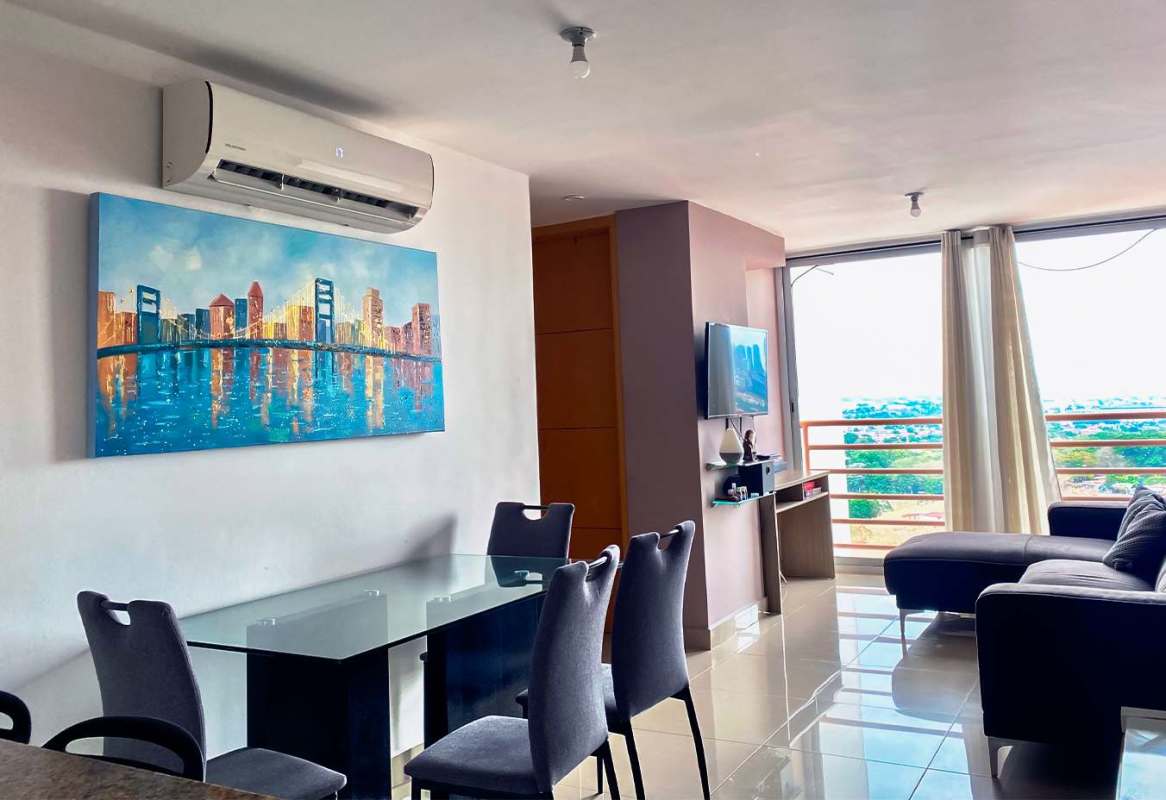 Open concept living and dining with large windows and AC in PH 4 Islas Panama rental