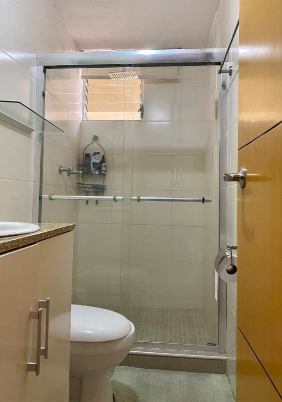 Minimalist bathroom with glass shower enclosure and modern fixtures in PH 4 Islas Panama