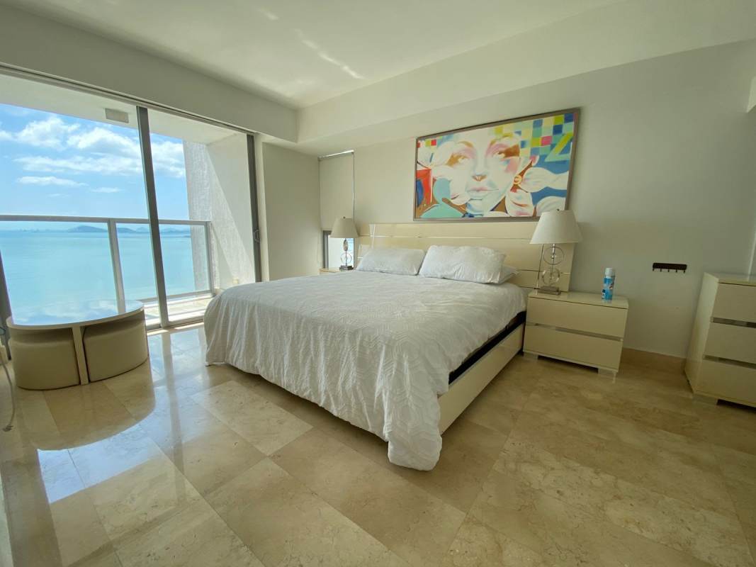 Bright living and dining area with panoramic city and ocean views at Yoo by Starck