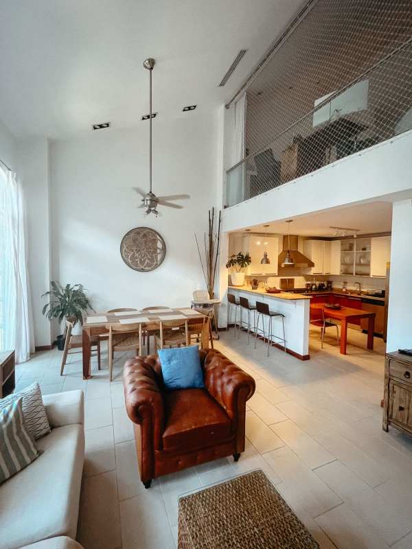 Double-height ceiling open loft with mezzanine, stone wall, modern furnishings PH Casco Antiguo Casco Viejo Panama